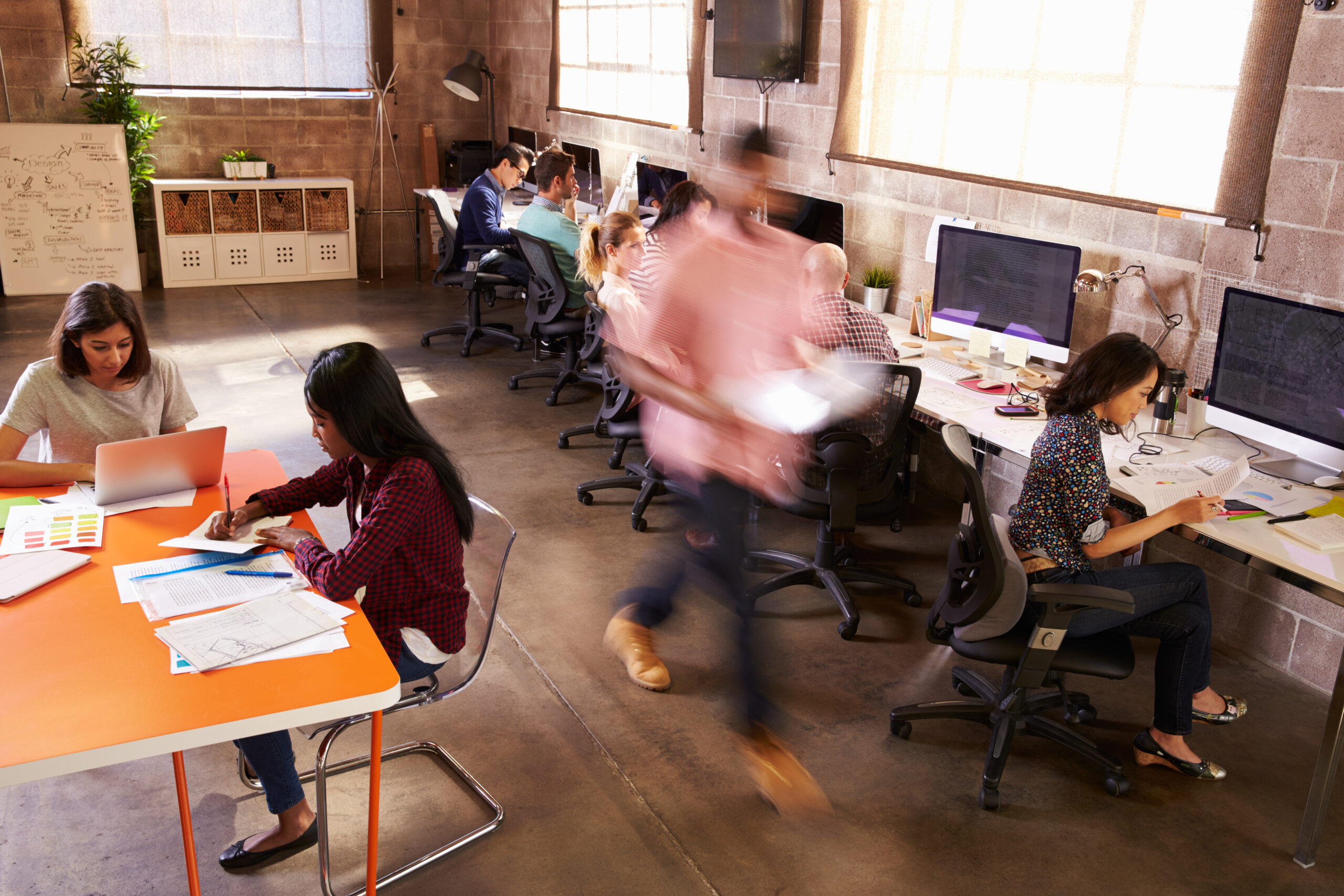 Elevated,View,Of,Workers,In,Busy,Modern,Design,Office